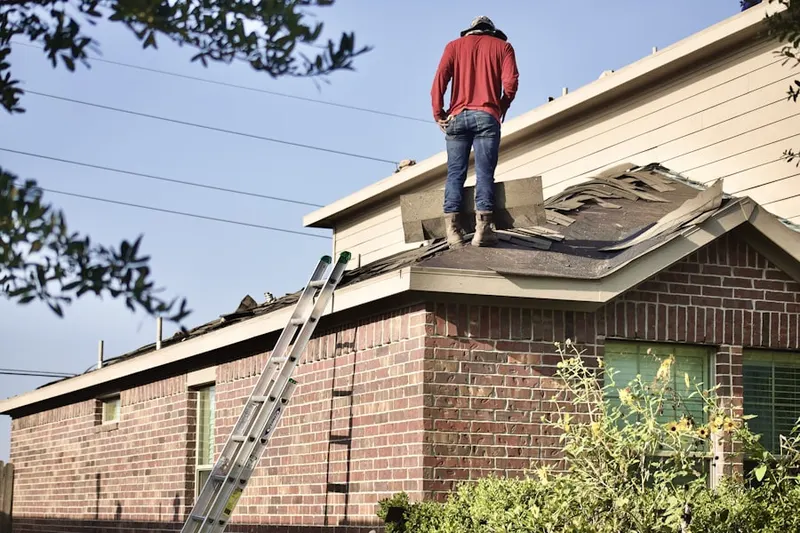 Professional roofer working on a residential roof in Old Fort